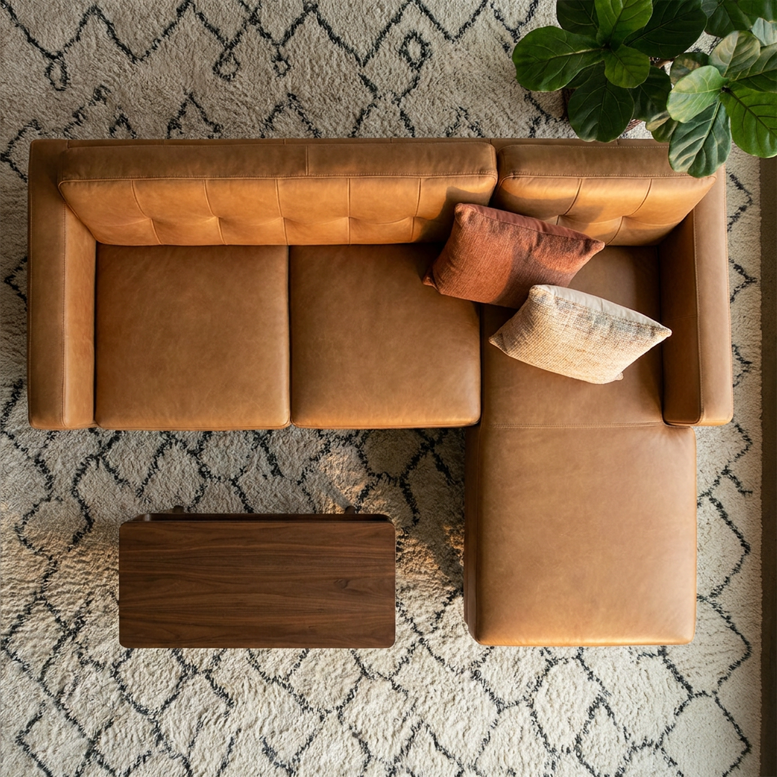 Brown leather sectional sofa with cushions on a patterned rug