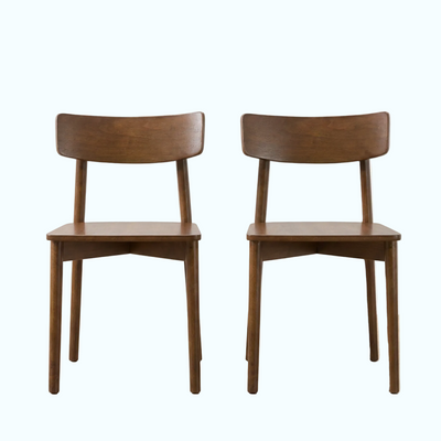 Two matching wooden dining chairs with curved backrests and angled legs, shown side by side on a light wood floor against a white wall.