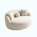 Modern beige sofa with cushions on a white background