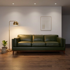 A three-seat olive green leather sofa in a modern living room setting with a gold floor lamp, wooden floor, and a minimalist framed print on the wall.