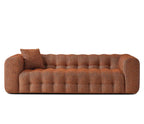 Brown sofa with tufted design on a white background