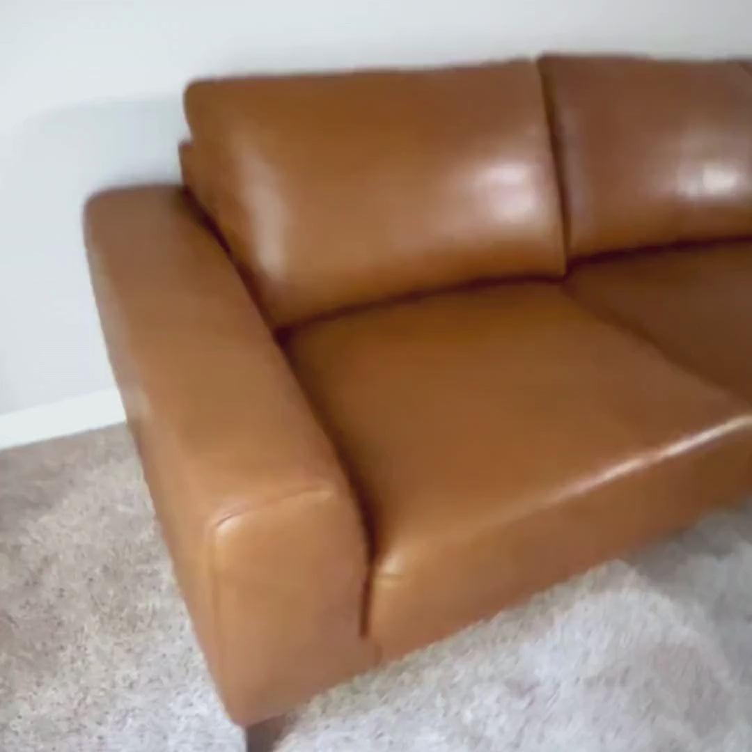 Top grain leather sectional sofa in a modern 1 bedroom apartment living room 